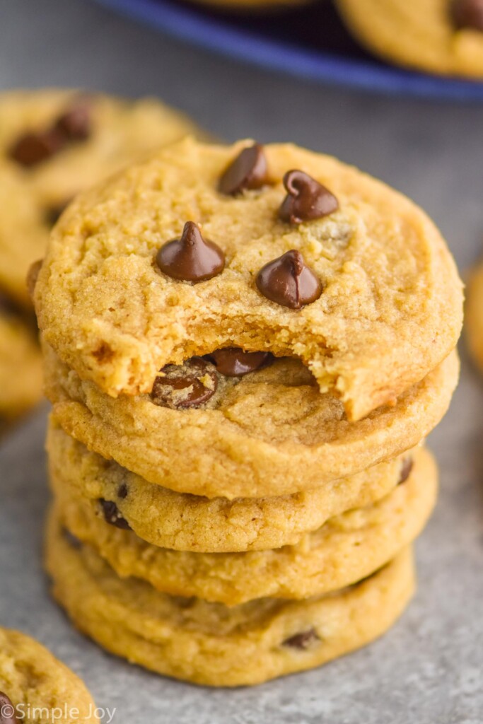 stack of chocolate chip peanut butter cookies with the top cookie missing a bite