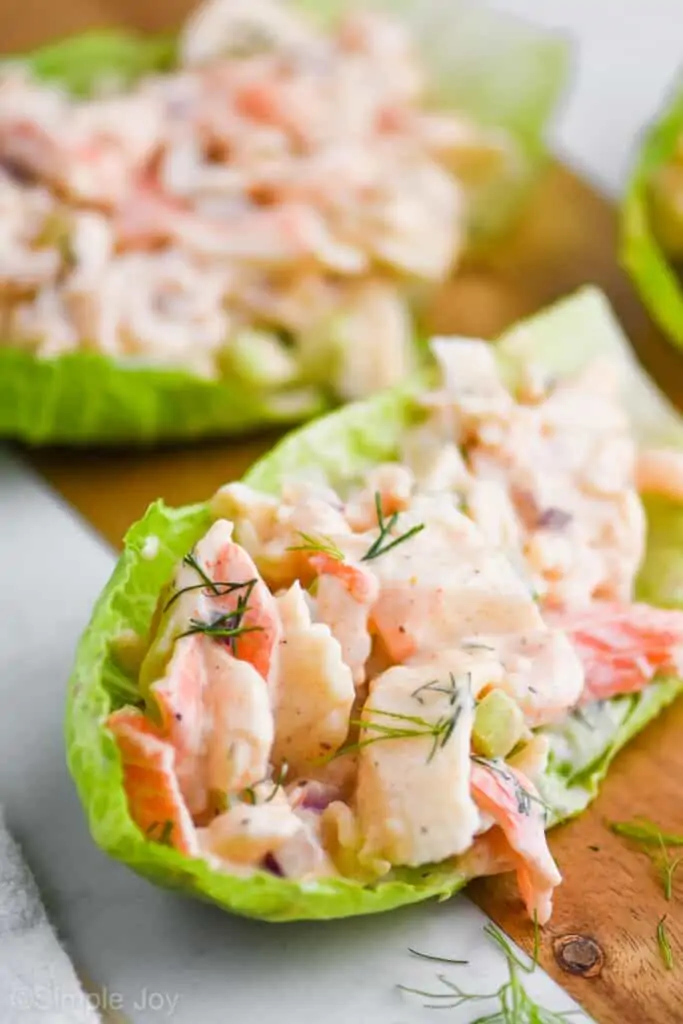 seafood salad in a lettuce cup garnished with fresh dill