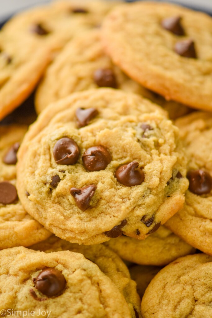 close up of a peanut butter chocolate chip cookie on a pile of more cookies
