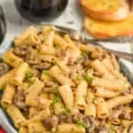 plate of beef and noodles recipe made with rigatoni noodles, ground beef, and mushrooms garnished with parsley