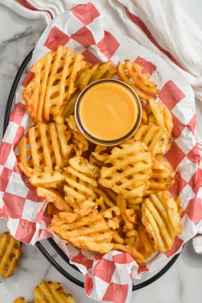 overhead of a basket of waffle fries with Chick Fil A sauce recipe