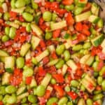 overhead view of an edamame salad, made and mixed, coated with dressing