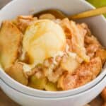 close up of an apple cobbler with vanilla ice cream on top and caramel sauce on that - 7