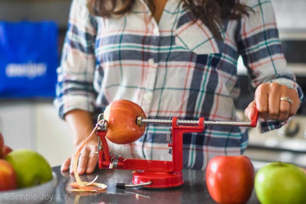 apple being peeled and cored by a machine