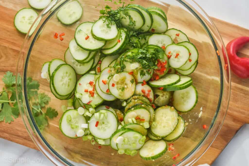 overhead of a mixing bowl full of the ingredients to make asian cucumber salad