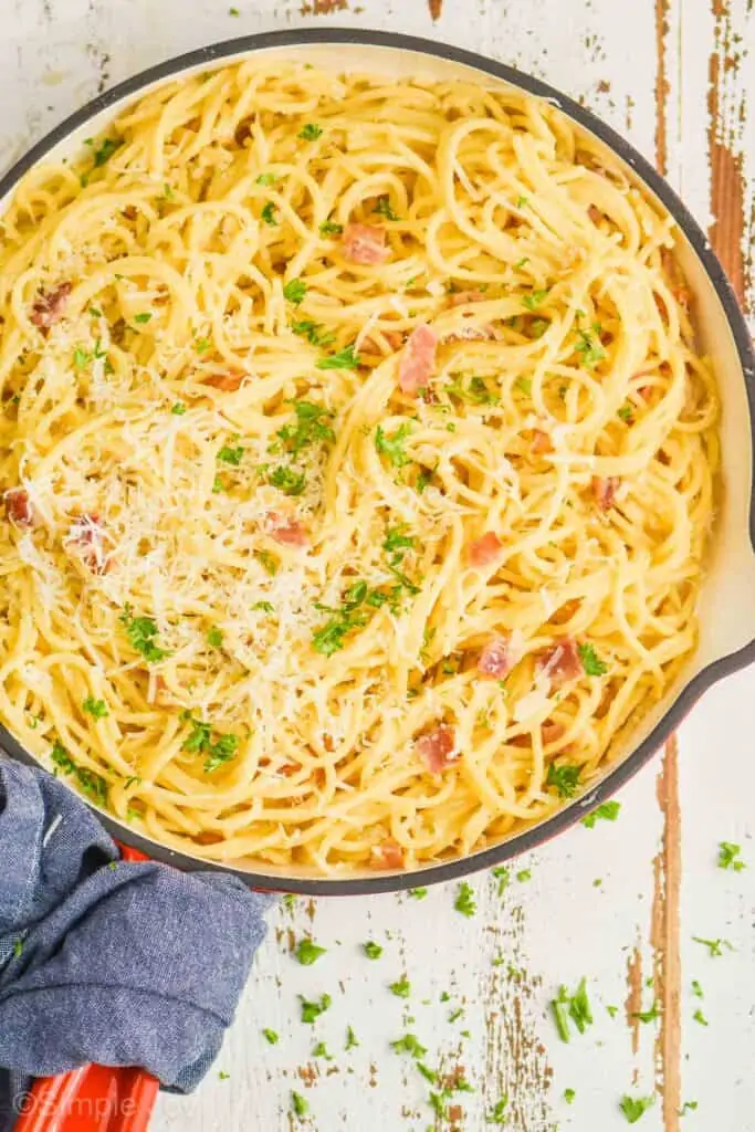 close up overhead view of a skillet full of pasta alla carbonara 