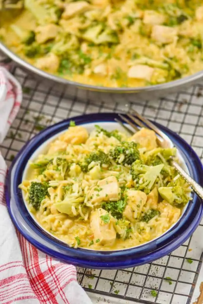 small blue plate with chicken broccoli rice casserole garnished with fresh parsley