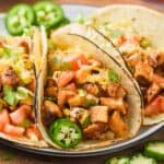 close up of a chicken taco on a plate with fresh jalapeño slice - 6
