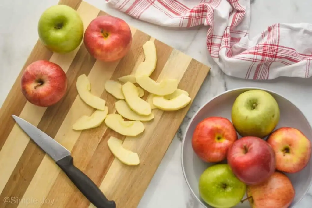 overhead photo of apples cut up on a cutting board