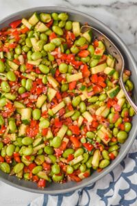 overhead view of an edamame salad, made and mixed, coated with dressing