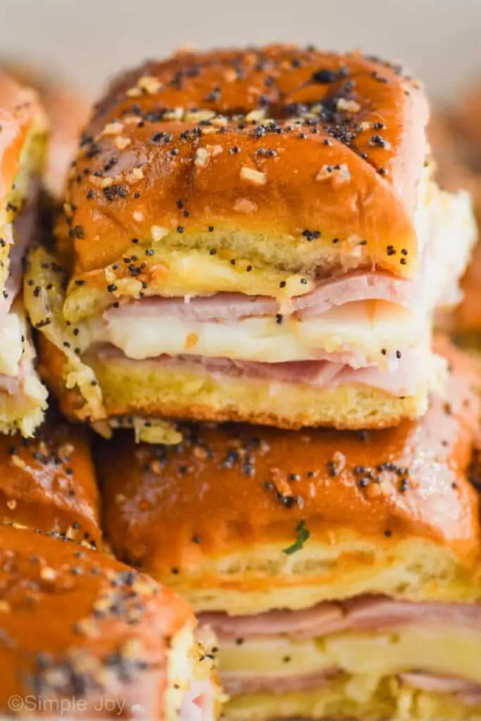 a batch of ham and cheese sliders recipe stacked one on top of the other