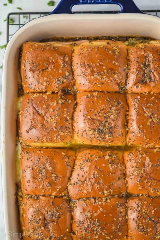 overhead view of hot ham and cheese sliders in a baking dish