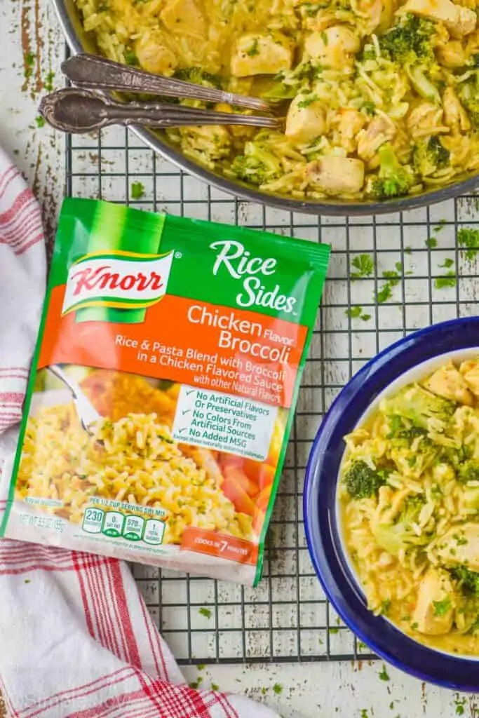 overhead view of a Knorr chicken broccoli rice side dish on a wire rack next to a skillet and a plate holding a chicken and broccoli rice casserole