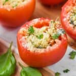 a baked stuffed tomato garnished with fresh parsley