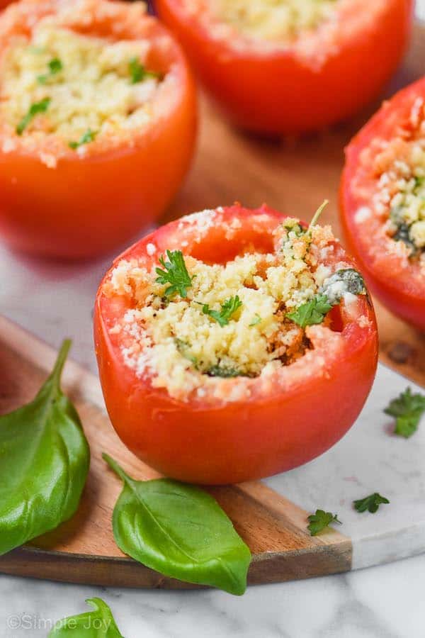 a baked stuffed tomato garnished with fresh parsley