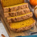 Pinterest graphic for Pumpkin Bread recipe. Image is overhead photo of sliced loaf of pumpkin bread. Text says, "Amazing Pumpkin Bread simplejoy.com"