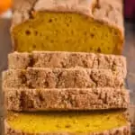 front of view of pumpkin bread sliced on cutting board