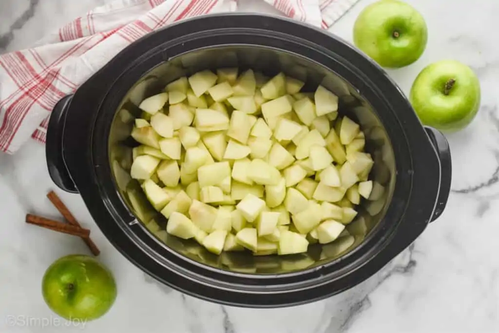 overhead view of chopped apples in a slow cooker