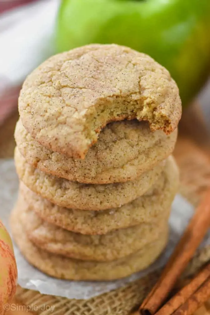 stack of apple cookie recipe with the top cookie missing a bite