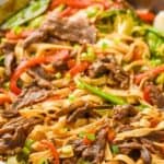 close up of a skillet full of beef lo mein