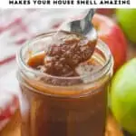 a small mason jar of an apple butter recipe that is being spooned up