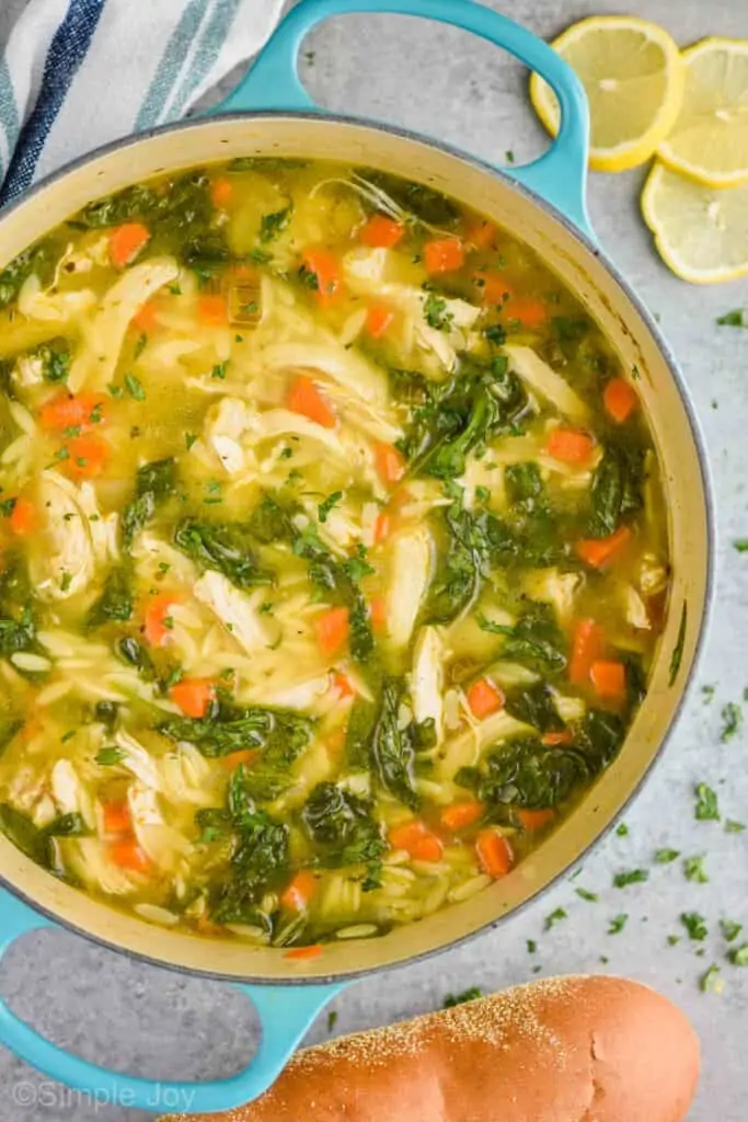 overhead of a dutch oven full of lemon chicken orzo soup
