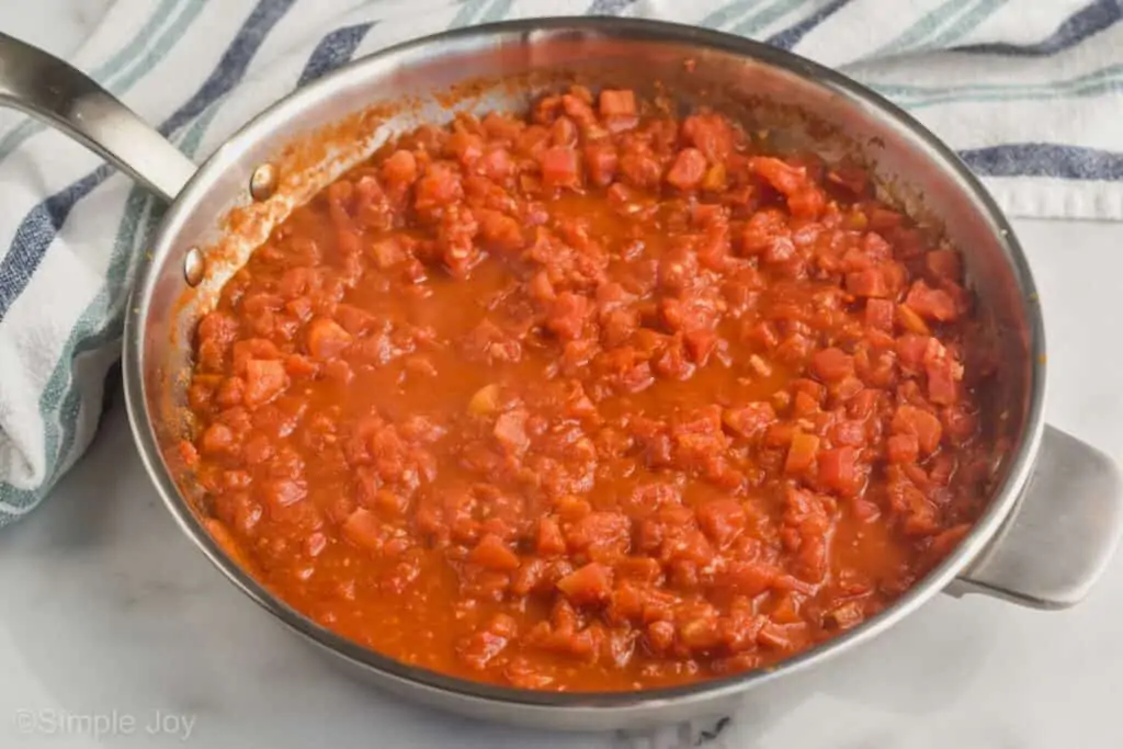 skillet full of tomato sauce to demonstrate the thickness it should be to make pasta puttanesca