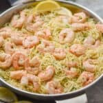 side view of a skillet full of shrimp scampi with angel hair pasta - 21