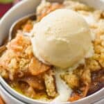 two white bowls stacked holding easy apple crisp recipe topped with ice cream