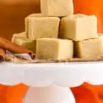 a pile of pumpkin fudge on a cake stand