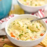 small white bowl full of chicken and dumplings garnished with fresh parsley - 11
