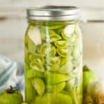 mason jar of pickled green cherry tomatoes and larger tomatoes - 13