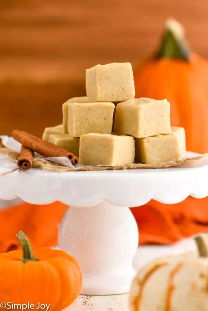 a pile of pumpkin fudge on a cake stand