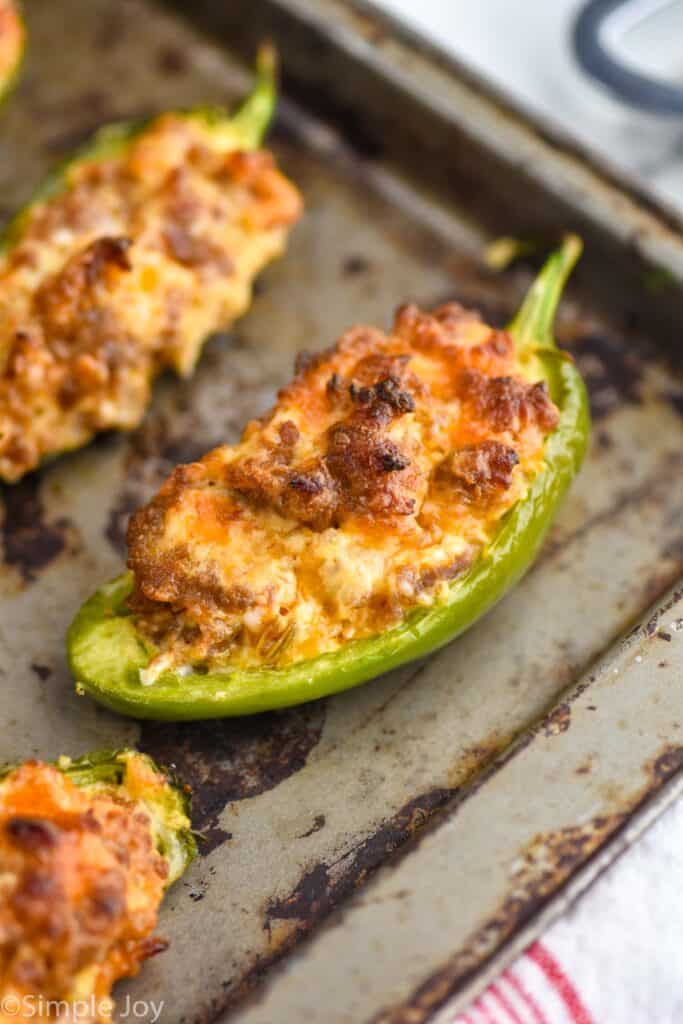 sausage stuffed pepper that has been baked on a rimmed baking sheet