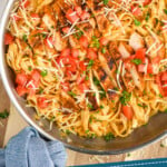 pinterest graphic of overhead of a skillet of cajun chicken alfredo on a cutting board, says "30 minute cajun chicken alfredo simplejoy.com"