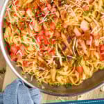 pinterest graphic of overhead of a skillet of cajun chicken alfredo on a cutting board, says "30 minute cajun chicken alfredo simplejoy.com"