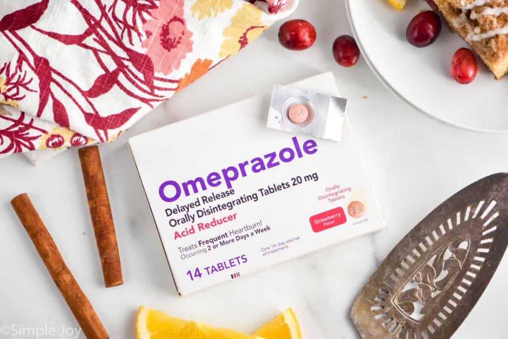 a box of omeprazole with one of the individual pills on top of the box