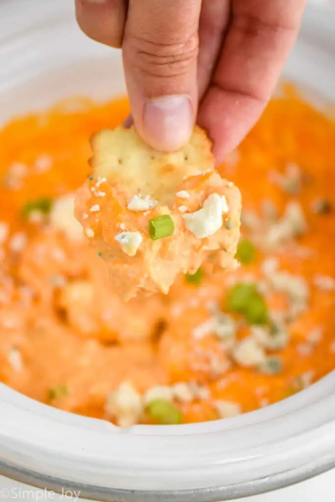 a cracker that has dipped into buffalo chicken dip