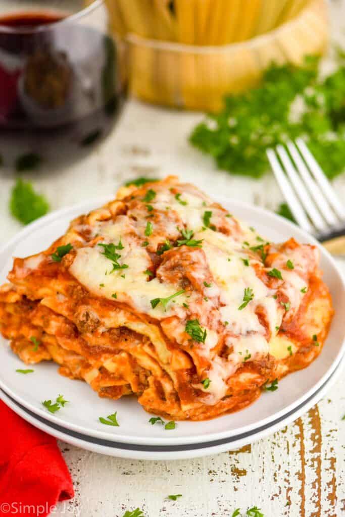 piece of crockpot lasagna on a plate garnished with parsley