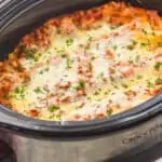 side view of a slow cooker full of crockpot lasagna