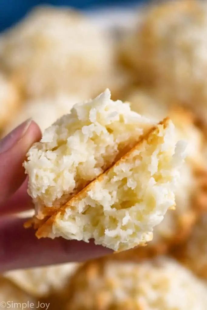 close up of a coconut macaroon with condensed milk broken in half