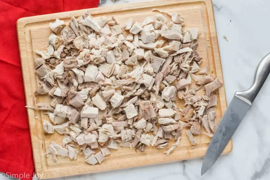 a cutting board full of cut up bite sized pieces of leftover turkey