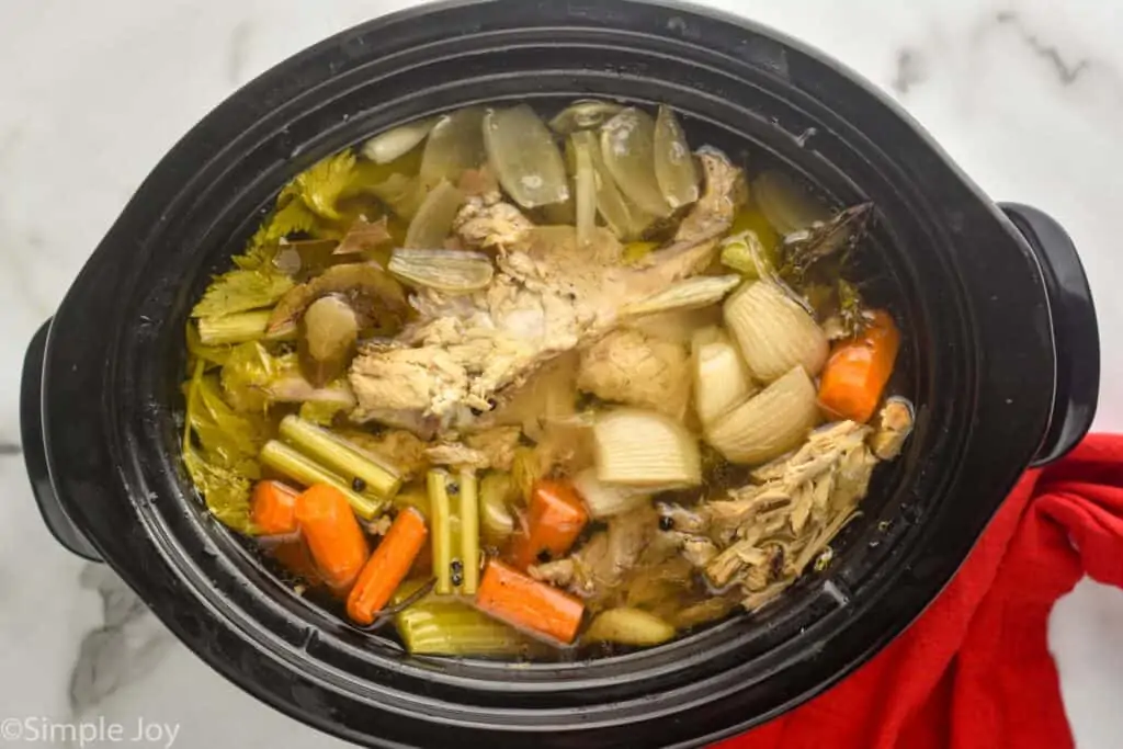 overhead view of a crockpot full of turkey broth