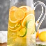 tall pitcher full of sangria with lemons, limes, and oranges - 6