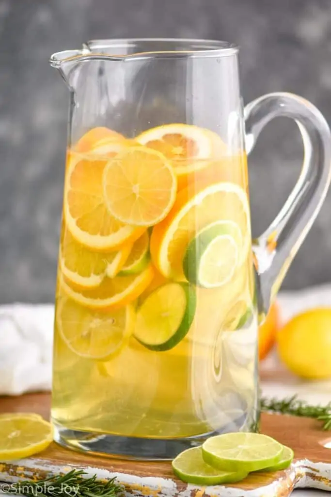tall pitcher full of sangria with lemons, limes, and oranges