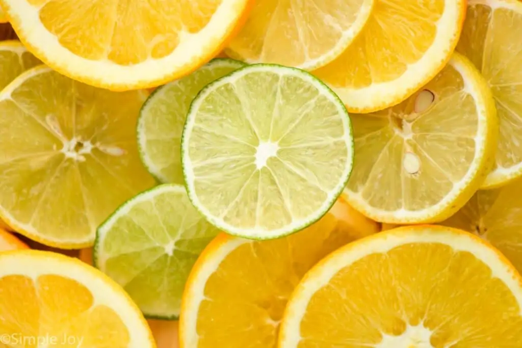 overhead close up photo of slices of lemons, limes, and oranges
