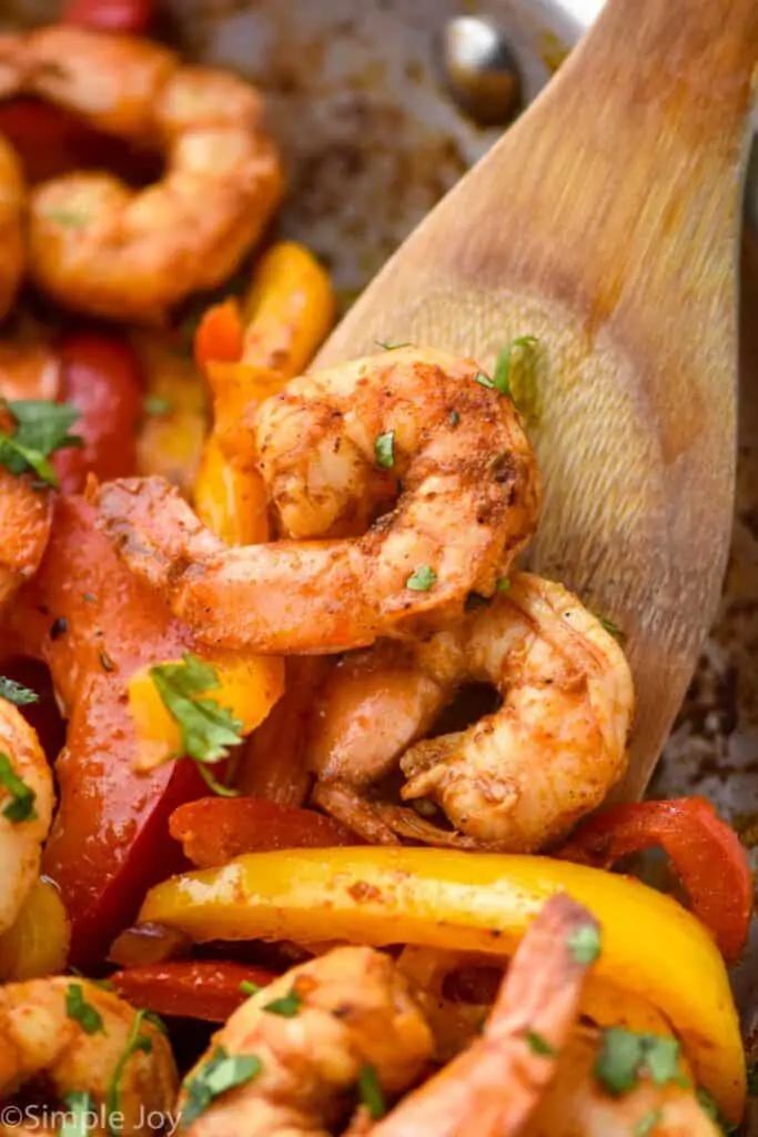 a spoon dishing up shrimp fajita filling