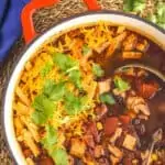 overhead view of stockpot full of turkey tortilla soup garnished with tortilla strips and fresh cilantro