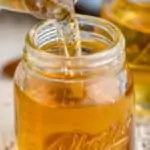 amaretto liqueur being poured into a small shot glass