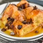 a square piece of croissant bread pudding smothered in brown sugar sauce